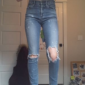 Mid-high rise skinny ripped jeans.